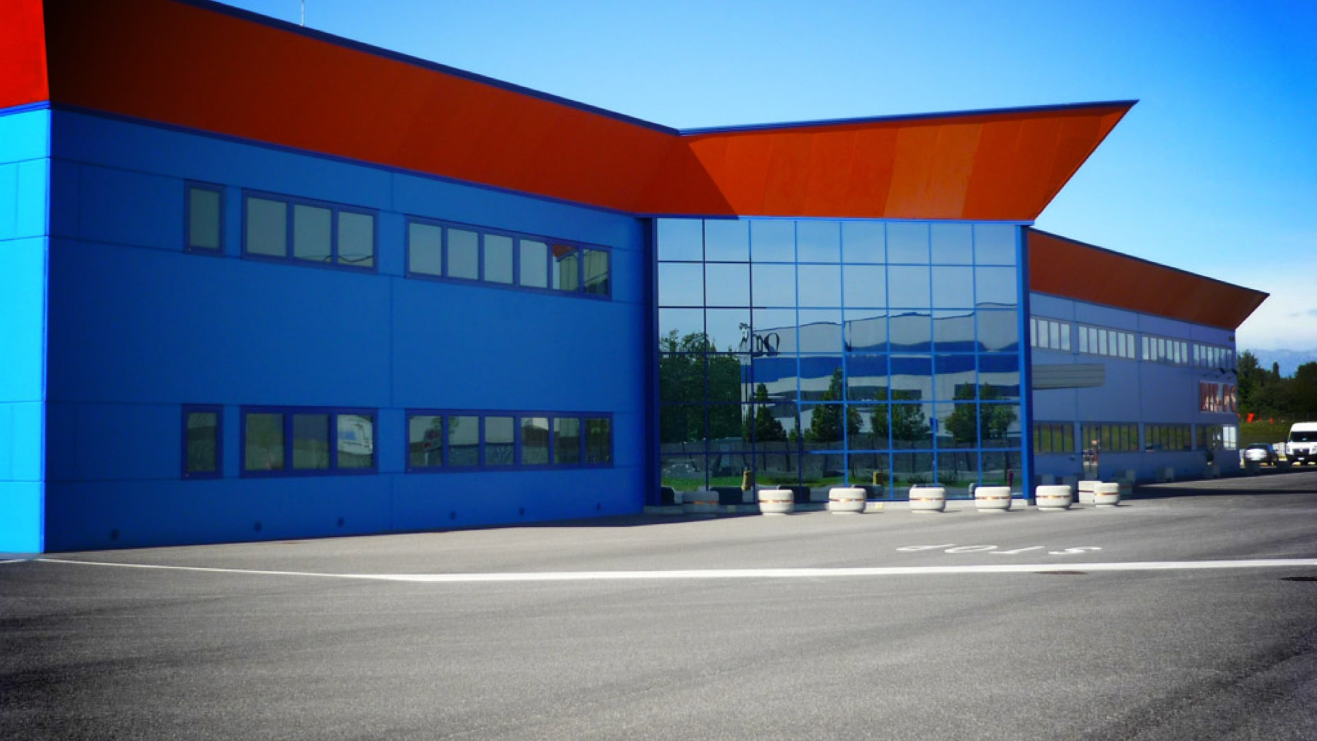 Sede DIS-PE con facciata blu, tetto arancione e vetrata centrale